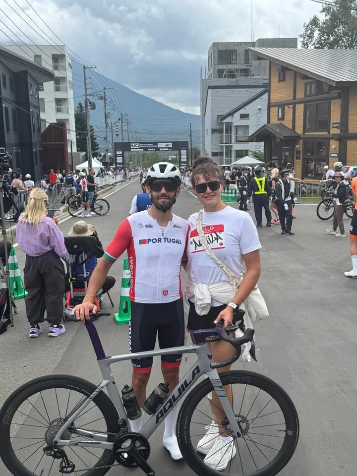 A cyclist with a bicycle and companion at a cycling event